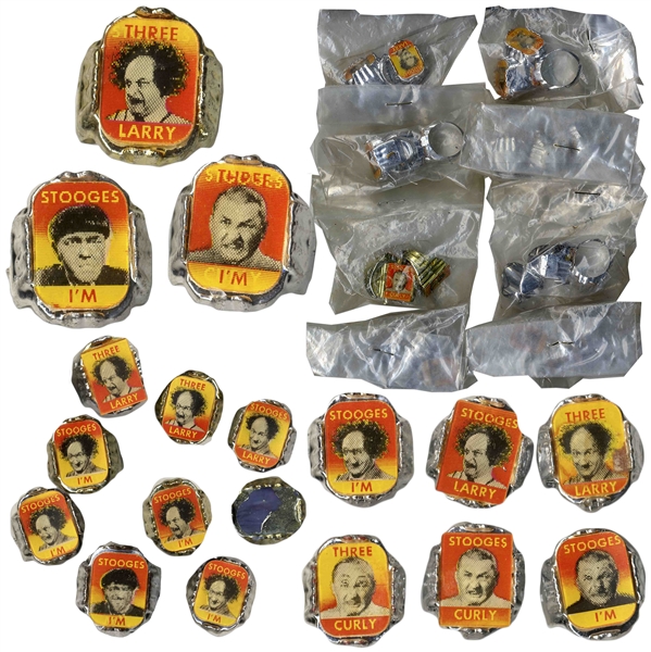 Lot of Three Stooges Toys: One 4 Button, 2 Rolls of Kinistil Film With Curly, 45 Rings, 3 Gum Dispensers, 2 Lighters (Non-Working) & 5 Eyeglass Cleaners -- Discoloration to Button, Else Very Good